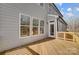 Rear exterior with deck and large windows offering view into wooded backyard at 5031 Mclaughlin Loop # 60, Waxhaw, NC 28173
