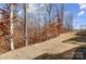 View of the sloping backyard with a view of the trees at 5031 Mclaughlin Loop # 60, Waxhaw, NC 28173
