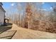 View of the sloping backyard with a view of the trees at 5031 Mclaughlin Loop # 60, Waxhaw, NC 28173