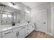 Bathroom featuring a double vanity with modern fixtures and tiled shower at 5031 Mclaughlin Loop # 60, Waxhaw, NC 28173
