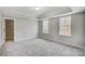 Bright bedroom featuring tray ceiling, carpet flooring, and large windows at 5031 Mclaughlin Loop # 60, Waxhaw, NC 28173