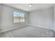 Bedroom with natural light from the large window and neutral-colored carpeted floors at 5031 Mclaughlin Loop # 60, Waxhaw, NC 28173