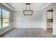 Bright, airy dining room with wainscoting and modern chandelier at 5031 Mclaughlin Loop # 60, Waxhaw, NC 28173