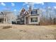 New two-story home featuring a stone facade, neutral siding, dark shutters, and an attached two-car garage at 5031 Mclaughlin Loop # 60, Waxhaw, NC 28173