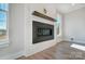 Close up on a modern fireplace with a wood mantel, flanked by windows and a beautiful plank wall at 5031 Mclaughlin Loop # 60, Waxhaw, NC 28173