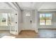 Bright foyer showcasing a paneled front door, classic trim, wood flooring, and a view to a bright office at 5031 Mclaughlin Loop # 60, Waxhaw, NC 28173
