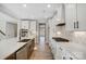 Modern kitchen boasts stainless appliances, sleek white cabinetry, quartz countertops and a spacious island at 5031 Mclaughlin Loop # 60, Waxhaw, NC 28173