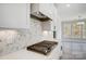 Gourmet kitchen featuring a gas cooktop, white cabinets, stone backsplash and granite countertops at 5031 Mclaughlin Loop # 60, Waxhaw, NC 28173