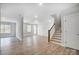 Open concept living room with wood flooring, and stairs at 5031 Mclaughlin Loop # 60, Waxhaw, NC 28173