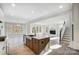 Open-concept living space with hardwood floors, large windows, and a cozy fireplace at 5031 Mclaughlin Loop # 60, Waxhaw, NC 28173