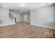 Spacious living room with light colored hard wood floors and staircase at 5031 Mclaughlin Loop # 60, Waxhaw, NC 28173