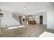 Open living space with hardwood floors, recessed lighting, and views into the kitchen and a staircase at 5031 Mclaughlin Loop # 60, Waxhaw, NC 28173