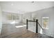 Sunlit loft with hardwood floors, multiple windows, and staircase with modern railing at 5031 Mclaughlin Loop # 60, Waxhaw, NC 28173