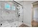 Modern bathroom with glass-enclosed marble tiled shower and black hardware at 5031 Mclaughlin Loop # 60, Waxhaw, NC 28173