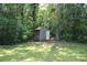 Backyard shed in a wooded back yard surrounded by trees at 510 Belmont Mount Holly Rd, Belmont, NC 28012