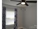 This bedroom boasts a ceiling fan and a bright window, creating a comfortable space at 510 Belmont Mount Holly Rd, Belmont, NC 28012