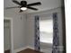 Cozy bedroom features a ceiling fan, window with curtains, and neutral-toned walls at 510 Belmont Mount Holly Rd, Belmont, NC 28012
