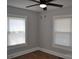 This is a cozy bedroom featuring two bright windows and a ceiling fan, creating a comfortable and inviting atmosphere at 510 Belmont Mount Holly Rd, Belmont, NC 28012