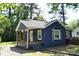 Charming blue home featuring a covered porch with wooden columns and shutters at 510 Belmont Mount Holly Rd, Belmont, NC 28012