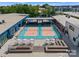Aerial view of community rooftop with pickleball courts and lounge area with umbrellas at 511 Bowman Rd, Charlotte, NC 28217