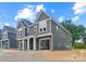 New two-story townhouse showcases gray siding, white trim, a covered entrance, and an attached two-car garage at 511 Bowman Rd, Charlotte, NC 28217