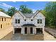 Exterior view of a new construction duplex featuring Tyvek wrap, a covered entrance, and attached garages at 511 Bowman Rd, Charlotte, NC 28217