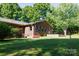 Brick home exterior with a well-manicured lawn and a charming patio at 567 Willie Ln, York, SC 29745