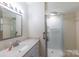 Bathroom with white fixtures, vanity, and glass enclosed shower at 567 Willie Ln, York, SC 29745