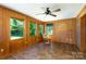 Sunroom featuring tile flooring, wood paneled walls, and natural light at 567 Willie Ln, York, SC 29745