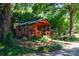 Exterior view of wooden cabin surrounded by mature trees and foliage at 567 Willie Ln, York, SC 29745