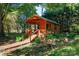 Exterior of a cozy wooden cabin with stairs and a small porch surrounded by trees at 567 Willie Ln, York, SC 29745