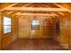 Interior of a wood cabin with wood floors, walls, and ceiling and several windows at 567 Willie Ln, York, SC 29745