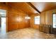 Dining room featuring wood paneled walls, built-in cabinets, chandelier, and tile flooring at 567 Willie Ln, York, SC 29745