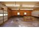 Wide angle view of garage with workspace, roll up garage door and natural light at 567 Willie Ln, York, SC 29745