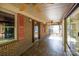 Spacious screened porch with brick pillars, decorative mosaic tile floor, and ceiling fans at 567 Willie Ln, York, SC 29745