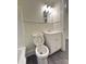 Bathroom featuring a white toilet, white vanity with sink, and a light fixture with multiple bulbs at 589 Fork Rd, Norwood, NC 28128