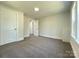 Bedroom featuring neutral colored walls, white trim, and newly installed carpet at 589 Fork Rd, Norwood, NC 28128