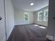 Bright bedroom features neutral carpet and two large windows that provide ample natural light at 589 Fork Rd, Norwood, NC 28128