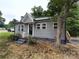 Charming one-story home with gray siding, black door and steps, and front yard with tree and flowers at 589 Fork Rd, Norwood, NC 28128