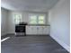 Bright kitchen with gray floors and fresh white paint, featuring stainless steel range at 589 Fork Rd, Norwood, NC 28128