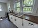 Bright kitchen featuring white cabinets, stylish dark hardware, and stainless steel oven at 589 Fork Rd, Norwood, NC 28128