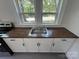 Bright kitchen with a stainless steel sink, new counter tops and white cabinets at 589 Fork Rd, Norwood, NC 28128