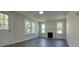 Living room featuring refinished hardwood floors, white paint, and a cozy decorative fireplace at 589 Fork Rd, Norwood, NC 28128