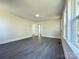 Spacious living room featuring refinished hardwood floors and freshly painted white walls at 589 Fork Rd, Norwood, NC 28128