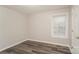 This bedroom has a window with blinds, updated floors and neutral paint at 592 Rambo E Rd, Rock Hill, SC 29730