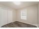 The bedroom has a built in closet, a window, and modern, gray flooring at 592 Rambo E Rd, Rock Hill, SC 29730