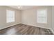 This bedroom boasts hardwood floors, a ceiling fan and abundant natural light from two large windows at 592 Rambo E Rd, Rock Hill, SC 29730