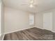 This bedroom features hardwood floors, a ceiling fan and a sunny window for ample natural light at 592 Rambo E Rd, Rock Hill, SC 29730