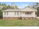 Inviting single-story house with a cozy front porch, brick foundation, and a well-kept lawn at 592 Rambo E Rd, Rock Hill, SC 29730