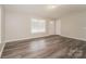 Spacious living room featuring hardwood floors, neutral paint, a window, and a modern front entry door at 592 Rambo E Rd, Rock Hill, SC 29730